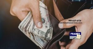 Man pulling cash out of his wallet - Franek Tax Services