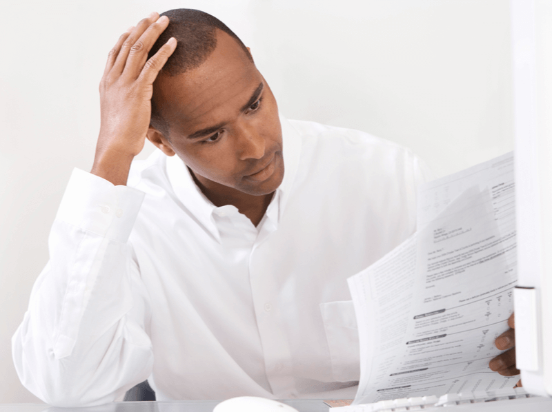 Man Looking Strangely at Tax Returns