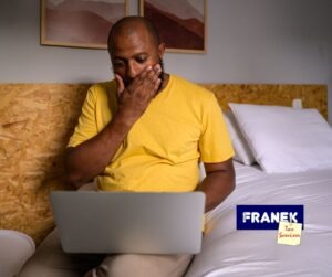 tax credit claims - Man with laptop and hand up to face - Franek Tax Services
